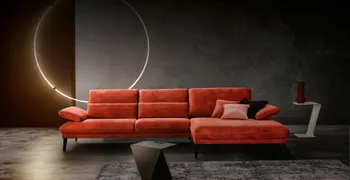 rotes Sofa vor dunklem Hintergrund mit ringförmigem Licht