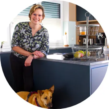 Junge Frau in dunkelblauer Küche