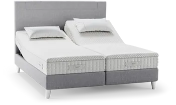 Ein verstellbares Svane® Zensation Bett mit hochwertigem grauem Polsterkopfteil und innovativer IntelliGel®-Matratze. Die geteilte Liegefläche ermöglicht individuelle Einstellungen für höchsten Schlafkomfort.